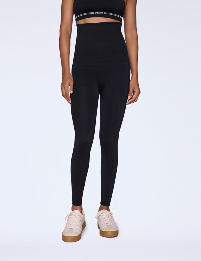 Woman wearing black high-rise, high-waisted shapewear leggings