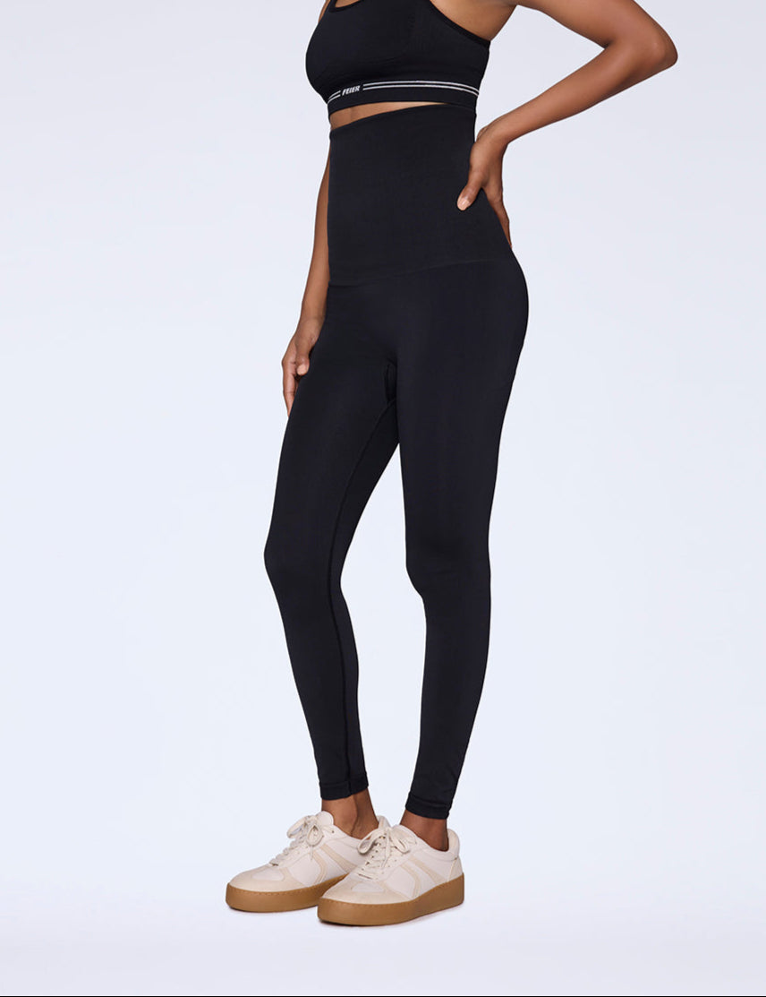 Woman wearing high-waist and high-rise black shaping leggings side view